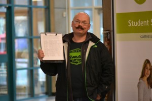 Camosun student Blair Roche holding his petition (photo by Jill Westby/Nexus).