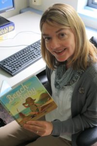 Camosun’s Laurie Elmquist holding her recently published book (photo by Adam Marsh/Nexus).