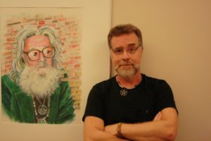 Local witch John Threlfall stands beside a drawing of pioneering Victoria witch Robin Skelton (photo by Adam Marsh/Nexus).